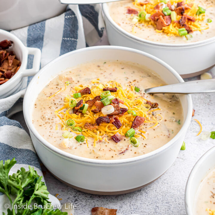 A bowl of creamy potato soup topped with cheese and bacon.
