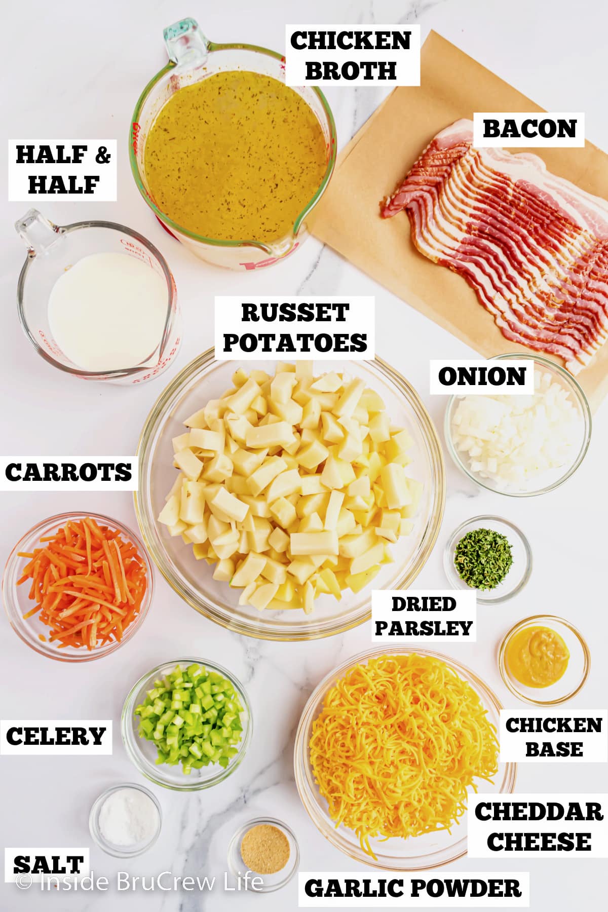 A white board with bowls of ingredients needed to make homemade potato soup.