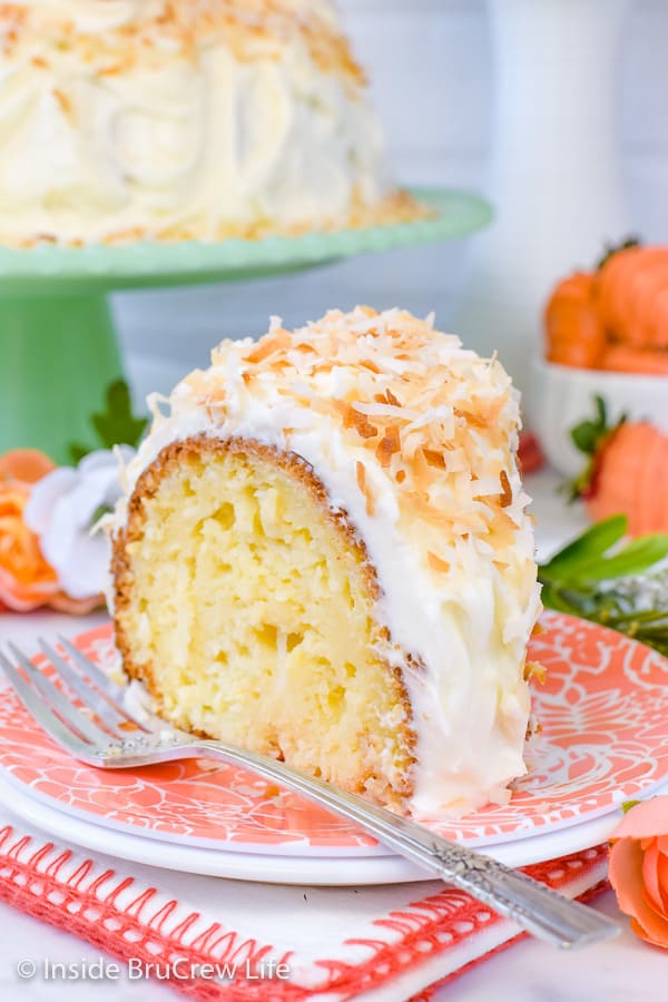 A slice of coconut bundt cake on a peach colored plate.