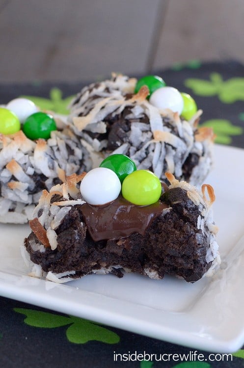 A chocolate cookie covered in toasted coconut and a fudge center.