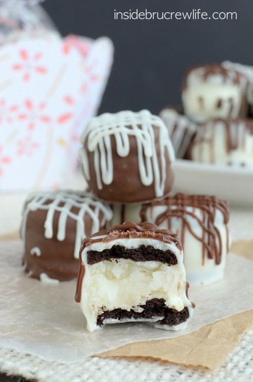 Mini ores stuffed with coconut cream and covered in chocolate stacked in a pile.