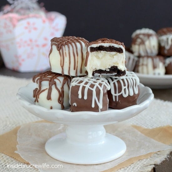 Mini ores stuffed with coconut cream and covered in chocolate stacked in a pile.