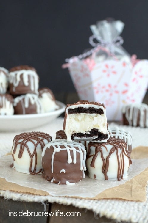 Mini ores stuffed with coconut cream and covered in chocolate stacked in a pile.