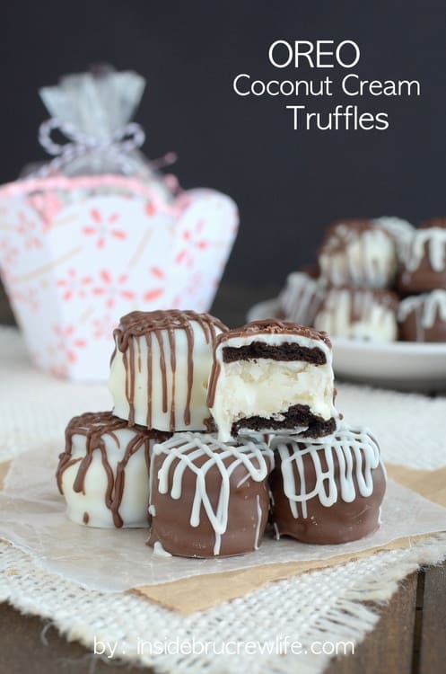 Mini ores stuffed with coconut cream and covered in chocolate stacked in a pile.