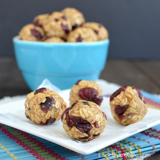 A white plate with peanut butter cranberry granola bites on it