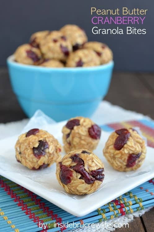 A white plate with four peanut butter cranberry granola bites on it