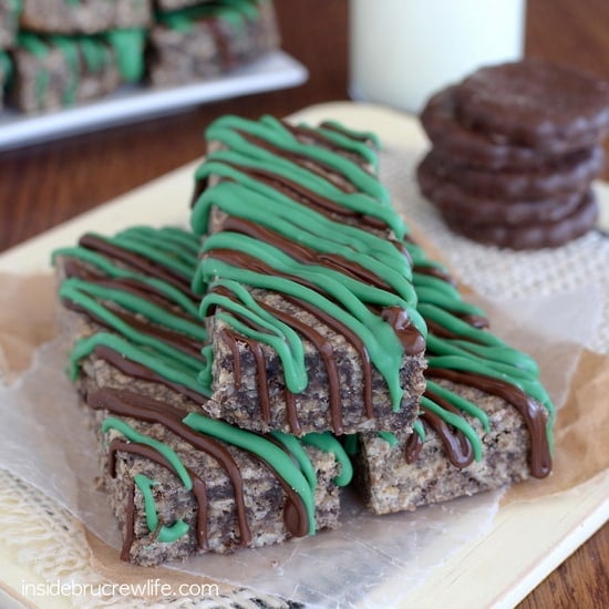 A tray with three thin mint granola bars drizzled with chocolate on it
