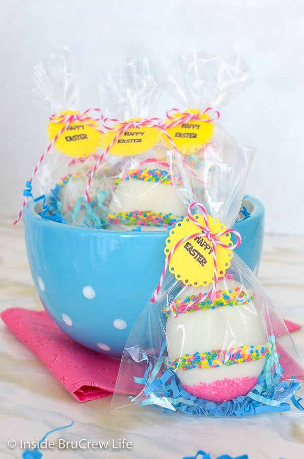 A blue bowl with Nutella cream eggs wrapped in cellophane bags with a yellow tag.