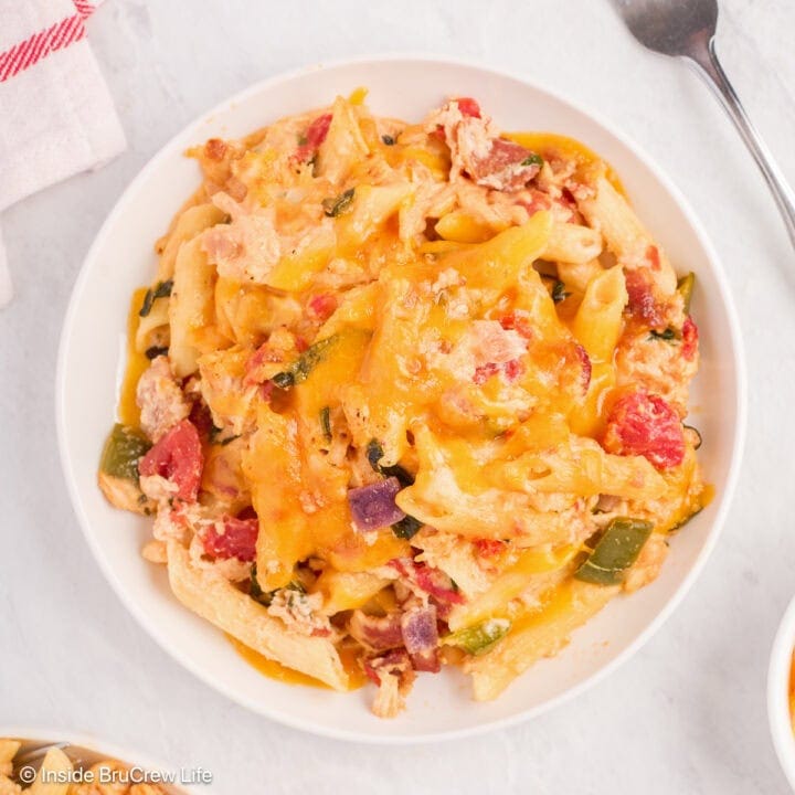 A white plate of cheesy pasta noodles.