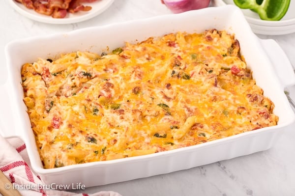 A white casserole dish with cheesy noodles baked in it.