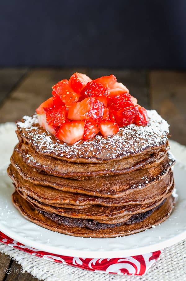 A white plate with a stack of chocolate protein pancakes on it.