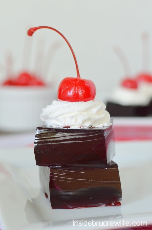 Squares of Jello stacked on a plate.