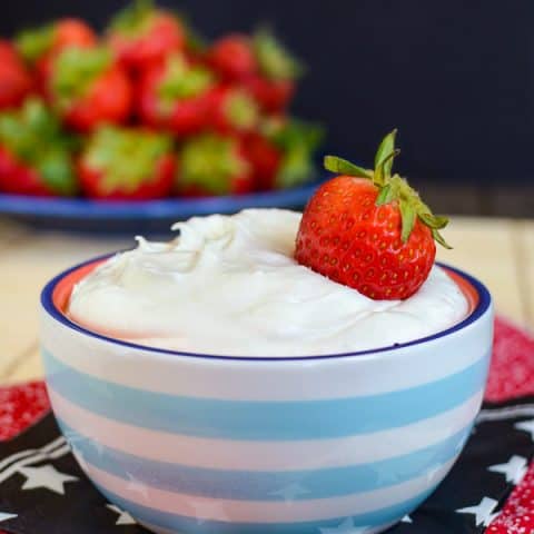 A blue and white bowl filled with coconut cream fruit dip