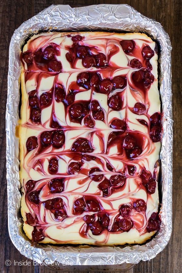 Overhead picture of a pan with swirled cherry cheesecake brownies in it