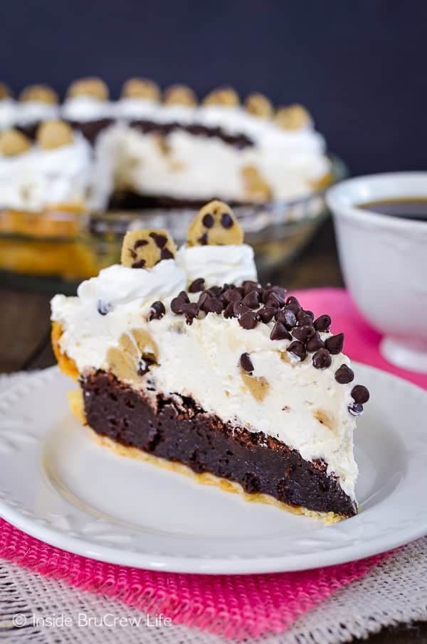 Cookie Dough Cheesecake Brownie Pie - the layers of fudge brownie, no bake cheesecake, and cookie dough make this a decadent and delicious dessert. Trust me and make this recipe for parties! #browniepie #cookiedoughbites #nobakecheesecake #bestdessert #cheesecakelove