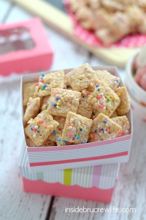 Crushed animal cookies and chocolate coat this easy muddy buddies snack mix.  It will disappear in a hurry!