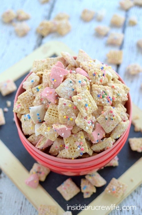 Crushed animal cookies and chocolate coat this easy muddy buddies snack mix.  It will disappear in a hurry!