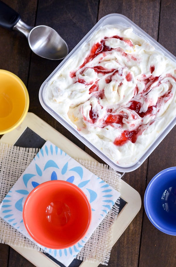 Lemon Oreo Strawberry Swirl Ice Cream - swirls of strawberry preserves and cookie chunks make this easy no churn ice cream so good. Make this easy recipe for the hot summer months. #icecream #lemon #homemade #nochurn #strawberry #summerdessert 