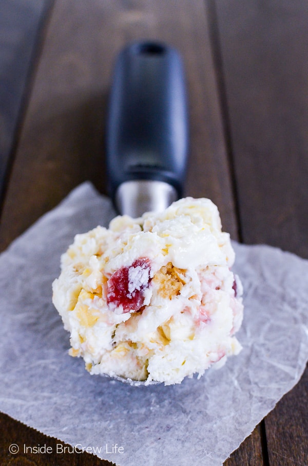 Lemon Oreo Strawberry Swirl Ice Cream - cookie chunks and strawberry swirls add so much fun to this easy no churn lemon ice cream. Try this recipe on a hot summer day! #icecream #lemon #homemade #nochurn #strawberry #summerdessert 