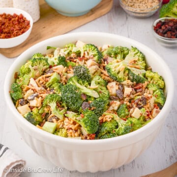 A large white bowl filled with a broccoli apple salad.