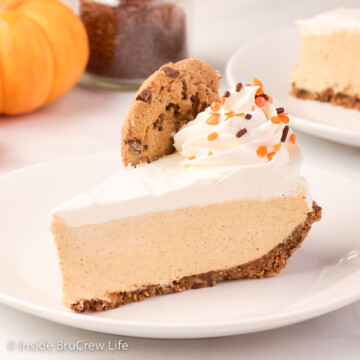 A slice of no bake pumpkin cheesecake on a white plate.