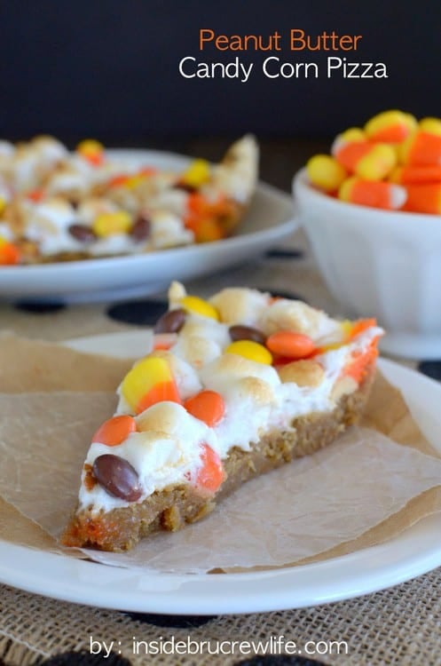 Peanut Butter Candy Corn Pizza - This giant peanut butter cookie is topped with melted marshmallows, peanuts, and candy corn. This is the perfect fall dessert! #cookie #fall #cookiepizza #peanutbutter #candycorn #dessertpizza #easy #recipe