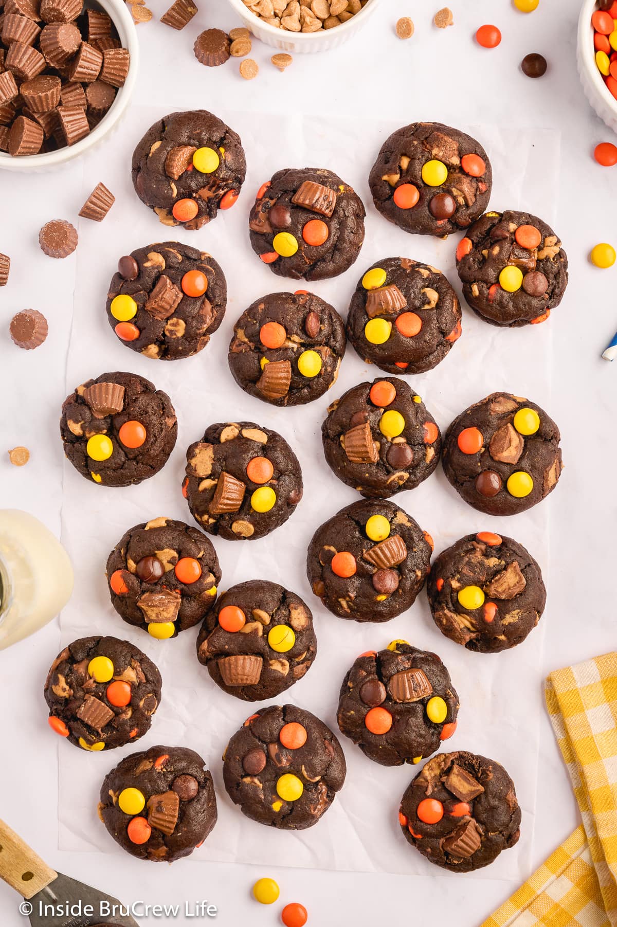 Chocolate cookies with candy on a white paper.