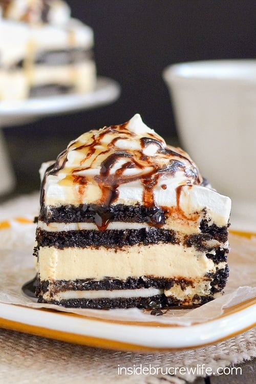 A close up picture of a piece of salted caramel Oreo icebox cake on a yellow plate showing the layers in the dessert