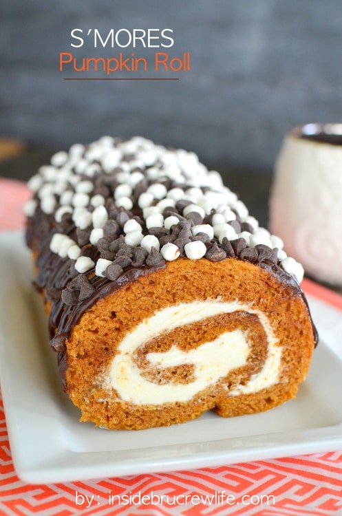 S'mores Pumpkin Roll - chocolate drizzles and marshmallow frosting adds a delicious flair to the classic pumpkin roll. Easy recipe to make this fall. #pumpkin #cakeroll #fall #smores #thanksgiving