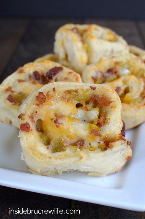Pizza dough with cheese, bacon and green chilis rolled up into it like a pinwheel.