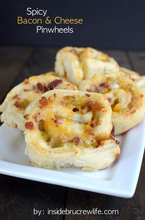 A plate full of pizza rolls stuffed with bacon and cheese.