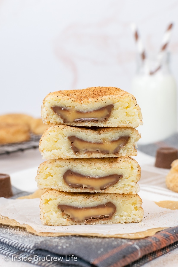 Four caramel cookies cut in half and stacked on a white paper.