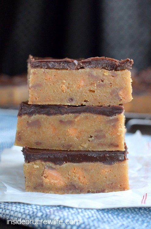 The rich decadent blonde brownies are full of Butterfinger candy bar chunks and topped with chocolate.  Good luck only eating one!