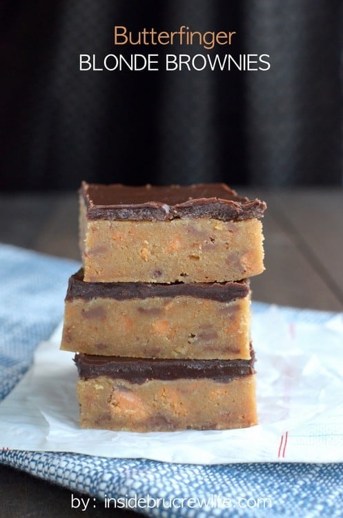 The rich decadent blonde brownies are full of Butterfinger candy bar chunks and topped with chocolate.  Good luck only eating one!