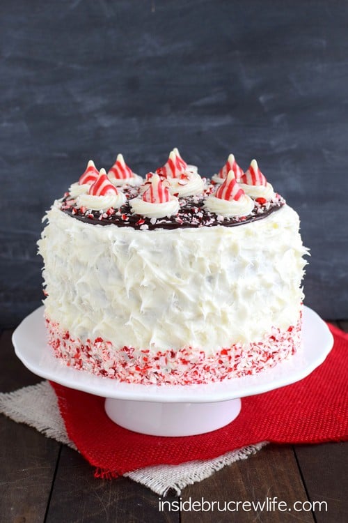 Candy Cane Chocolate Cheesecake Cake - layers of cake, cheesecake, and peppermint frosting makes this holiday cake so pretty and delicious! Great recipe for holiday parties!