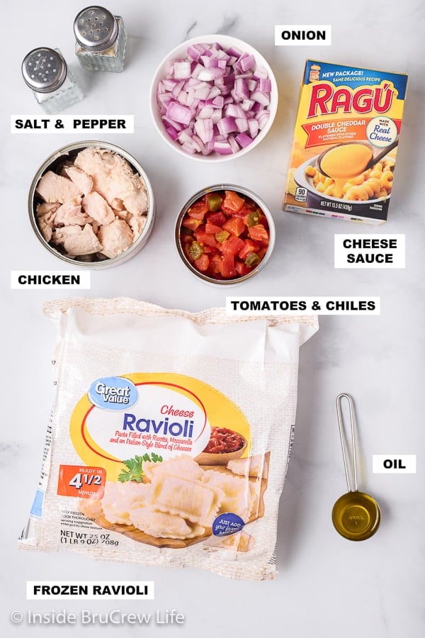 A white board with the ingredients needed to make a pan of nacho chicken ravioli.