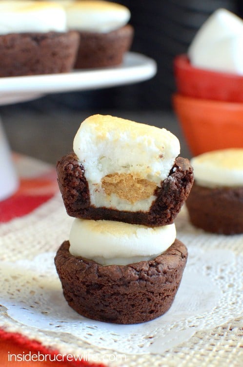 Mini brownie bites stuffed with peanut butter cups and topped with a toasted marshmallow for a fun s'mores twist!