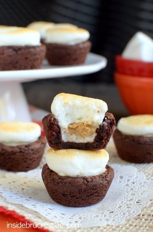 Mini brownie bites stuffed with peanut butter cups and topped with a toasted marshmallow for a fun s'mores twist!