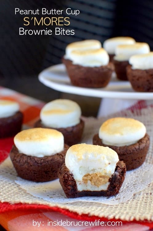 Mini brownie bites stuffed with peanut butter cups and topped with a toasted marshmallow for a fun s'mores twist!