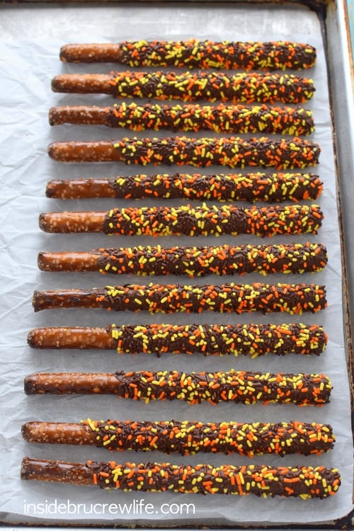 Overhead picture of a tray of chocolate covered pretzels with fall sprinkles.