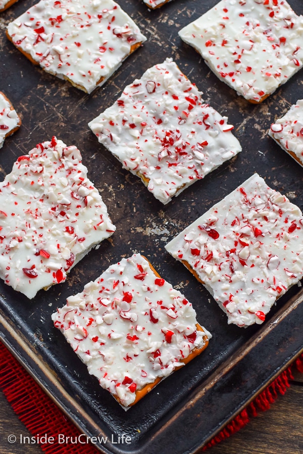 A metal tray with squares of candy cane pretzel bark on it