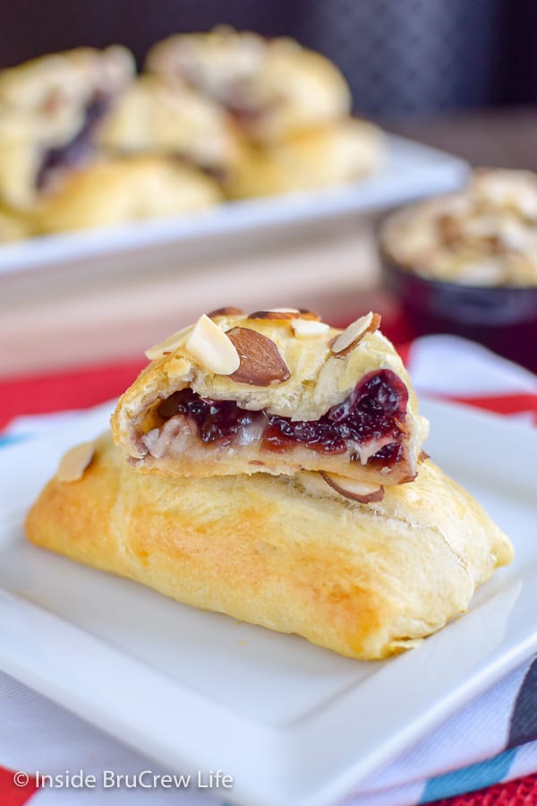 A white plate with cherry brie pockets on it.