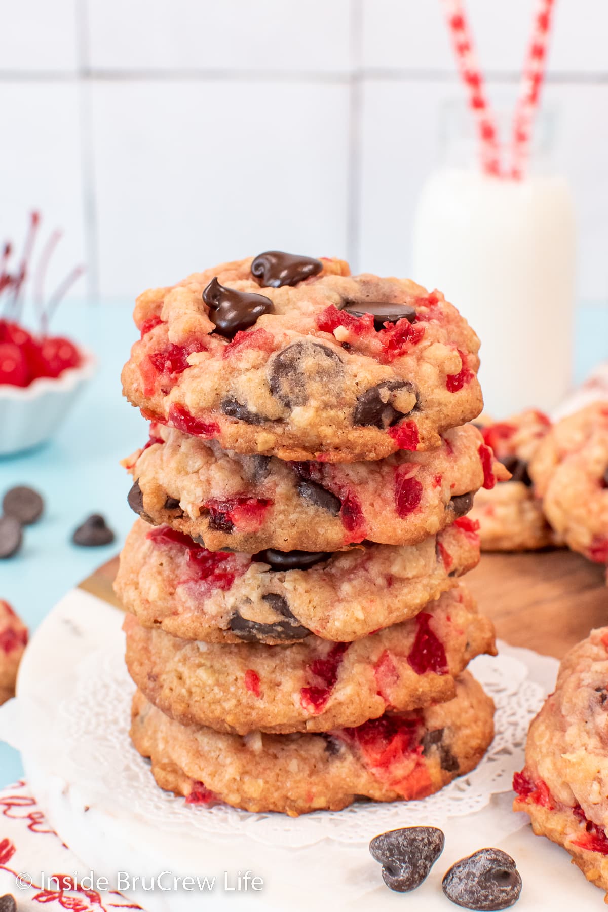 A stack of cherry chip cookies on a tray.