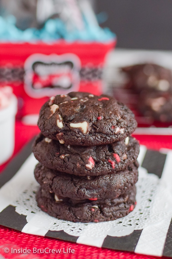 Four chocolate peppermint cookies stacked on top of each other on a black and white napkin.