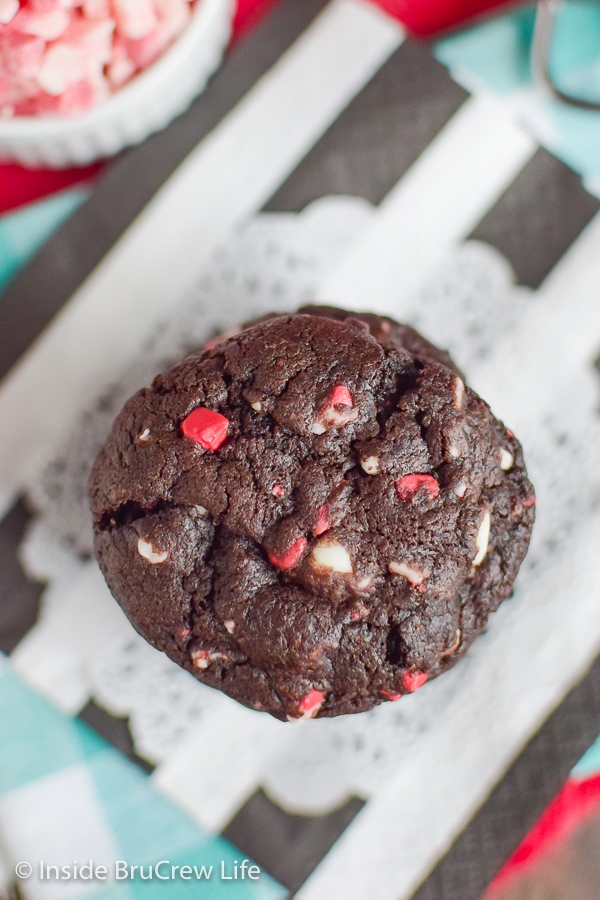 Overhead picture of a stack of chocolate peppermint crunch cookies on a white and black napkin.