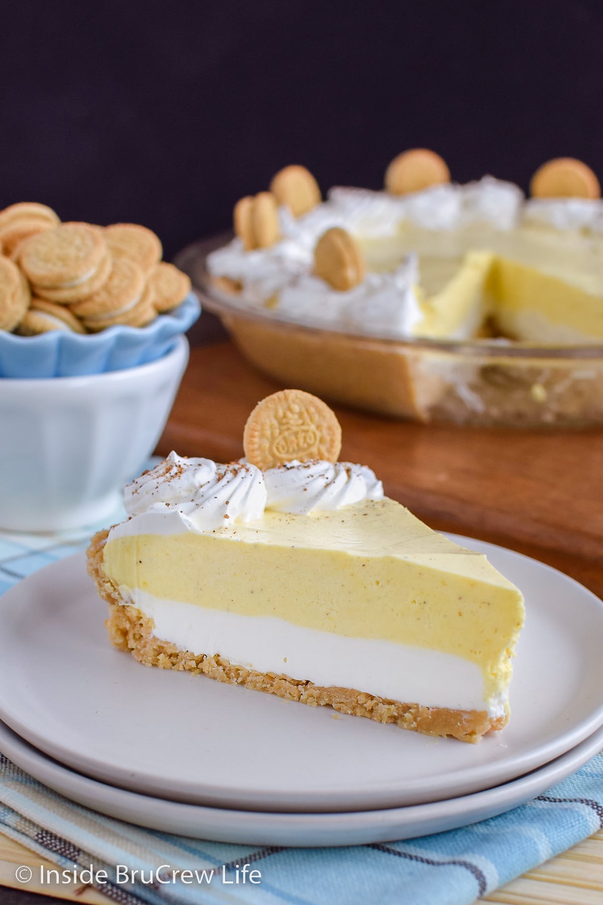 A slice of no bake eggnog pie on a white plate.