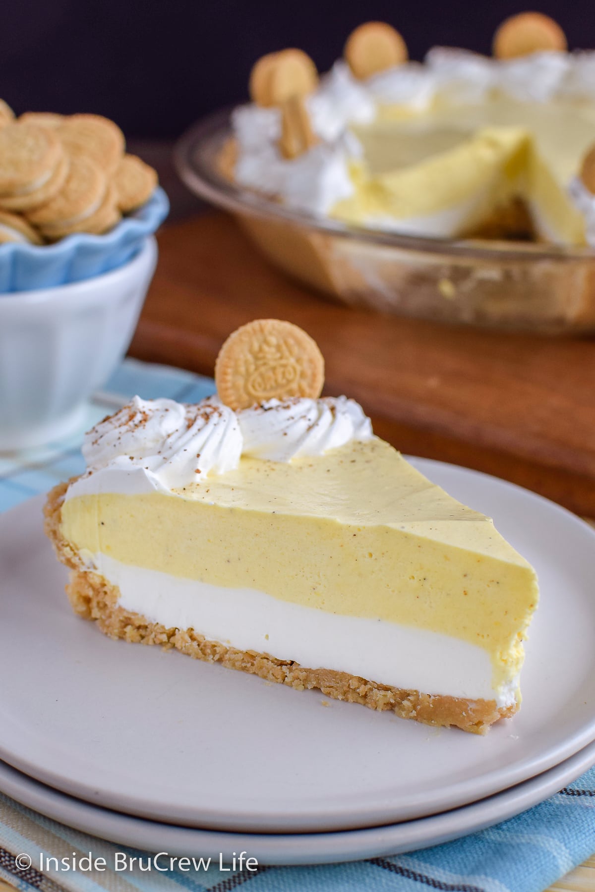 A white plate with a slice of eggnog pie on it.