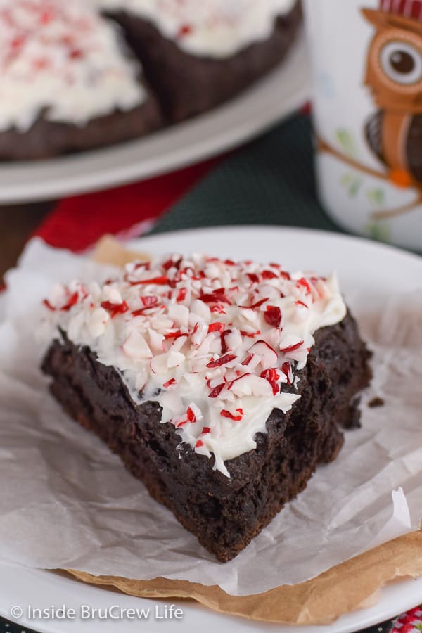 A Peppermint Mocha Scone with white frosting on a white plate.