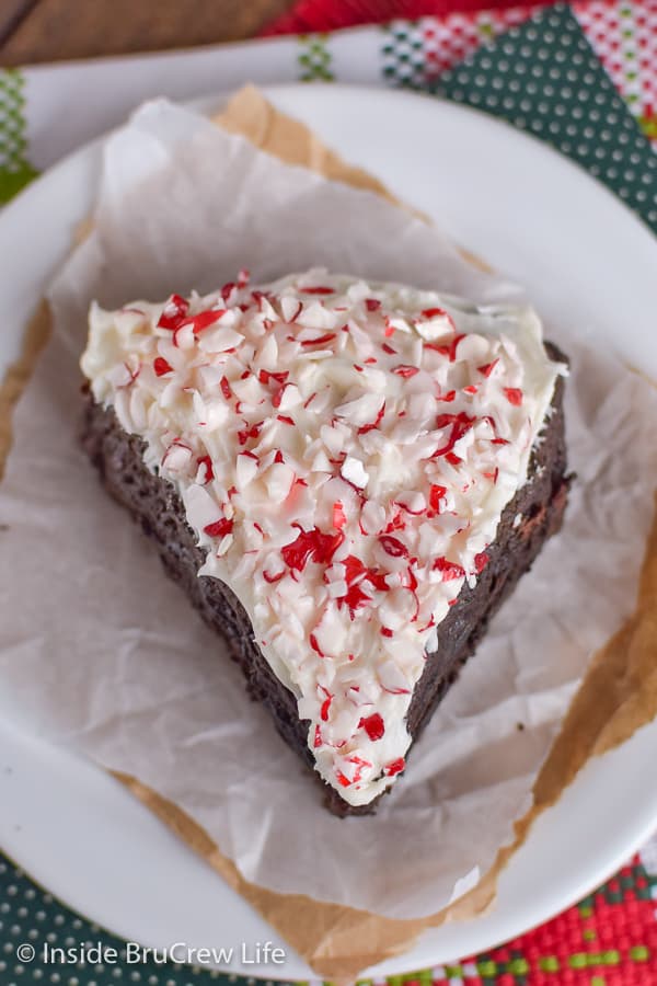 A single peppermint mocha scone on a white plate with some parchment paper.