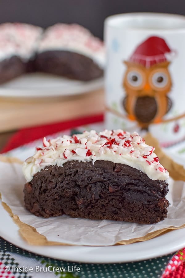 Close up picture of a peppermint mocha scone with an owl coffee cup in the background.